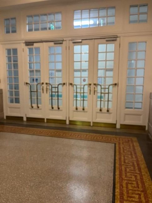 Glass doors to the left of the statue